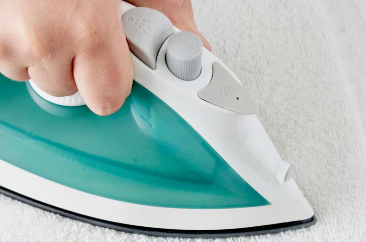 An iron can help you remove permanent marker from rugs.