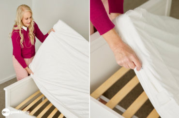 A woman wearing pink flipping a mattress.