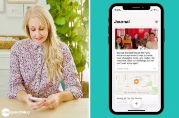 A woman is sitting at a table with a phone in front of her, using a journal app.