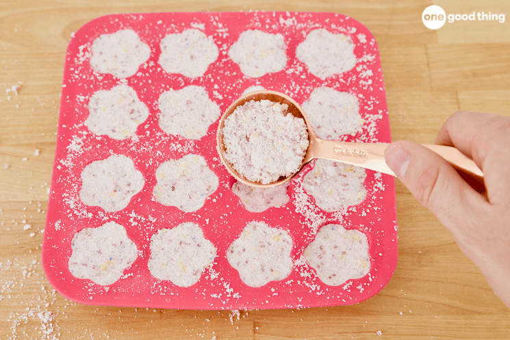 To mold the Laundry Detergent Tabs, scoop a tablespoon of your damp homemade laundry detergent into each cavity in the mold or ice cube tray.