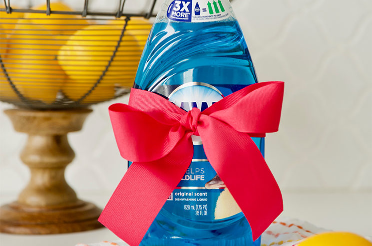 blue dawn dish soap sitting on a kitchen counter wrapped with a pink bow