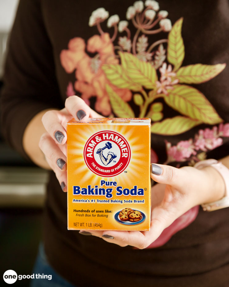 Photo of a woman holding a box of baking soda.