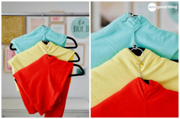 Colorful cardigans in red, yellow, and turquoise hang neatly on hangers using a soda tab to layer the hangers. A great tip for saving closet space!