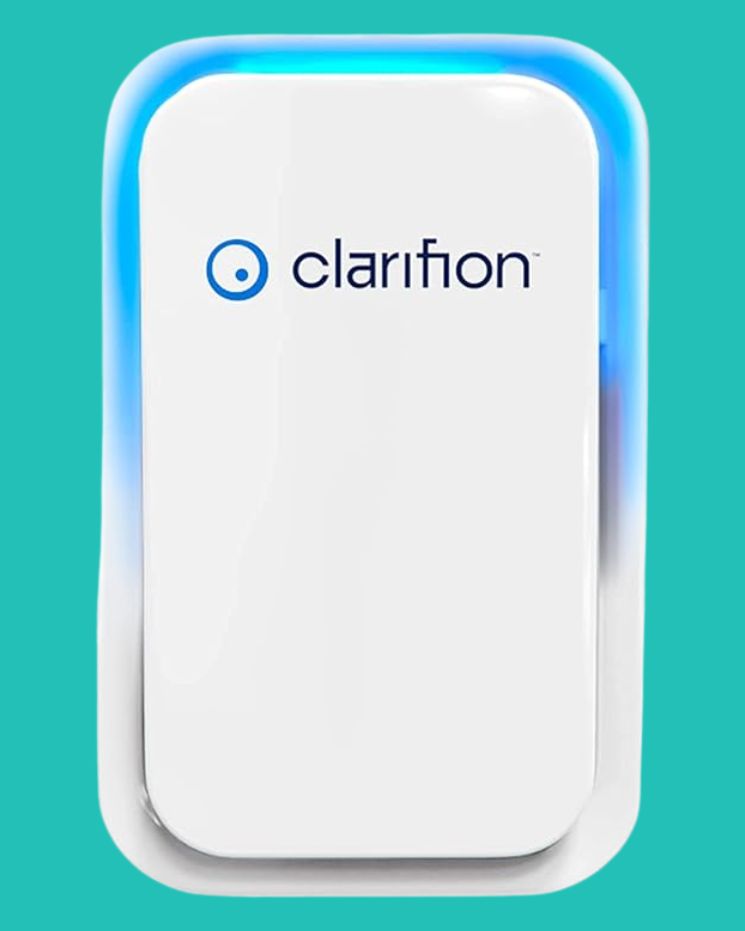 A Clarifion air purifier device with a white rectangular body and a blue light border, against a solid teal background, offering an innovative way on how to get rid of static in clothes.