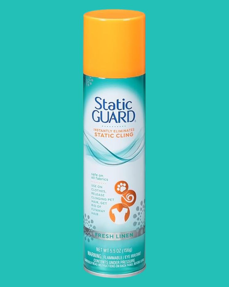 A canister of Static Guard spray with a bright orange cap against a teal background. The label indicates it is for eliminating static cling and is safe on all fabrics. A go-to solution for anyone wondering how to get rid of static in clothes, plus it has the refreshing Fresh Linen scent.