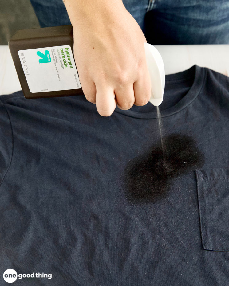 First step to getting out oil stains is to spray the stain with hydrogen peroxide.