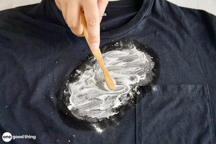 Scrub the cleaners into the oil stain.