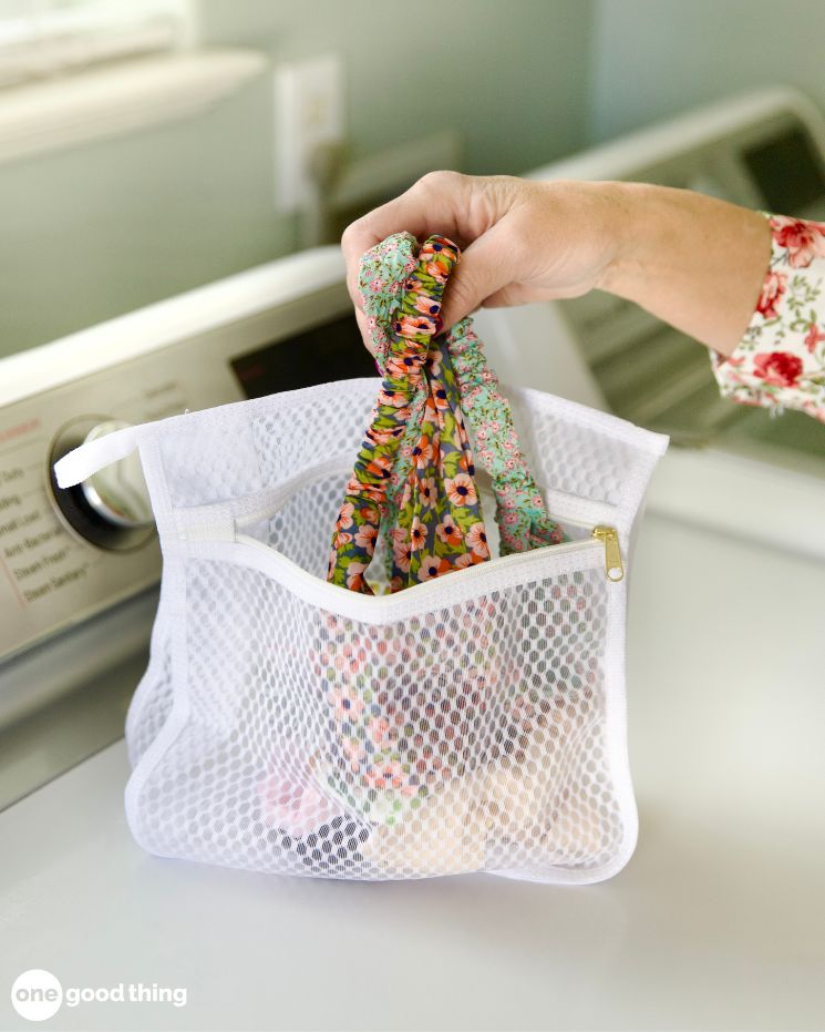 Loading a laundry bag but not crowding the items.