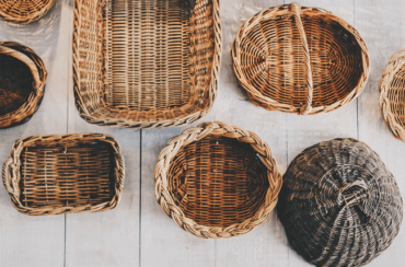 Clean wicker baskets arranged on a wooden surface.