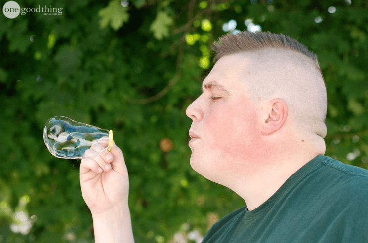 man blowing a bubble