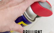 A hand holding a red-capped WD-40 can. The image text reads, "Brilliant WD-40 Uses You Should Know!