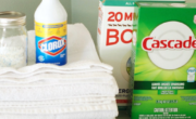 A laundry room equipped with towels, soap, and a bottle of laundry detergent to tackle any laundry problems.