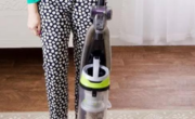 The best vacuum guide features a woman confidently holding one of the top-rated vacuums.